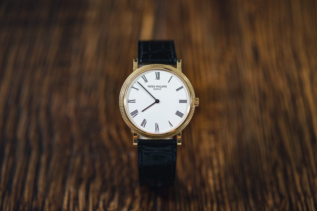 A gold case, white dial Patek Philippe with stick hands 