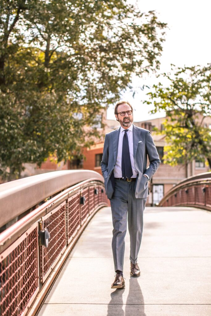 Sid Mashburn walking across the bridge near his store 