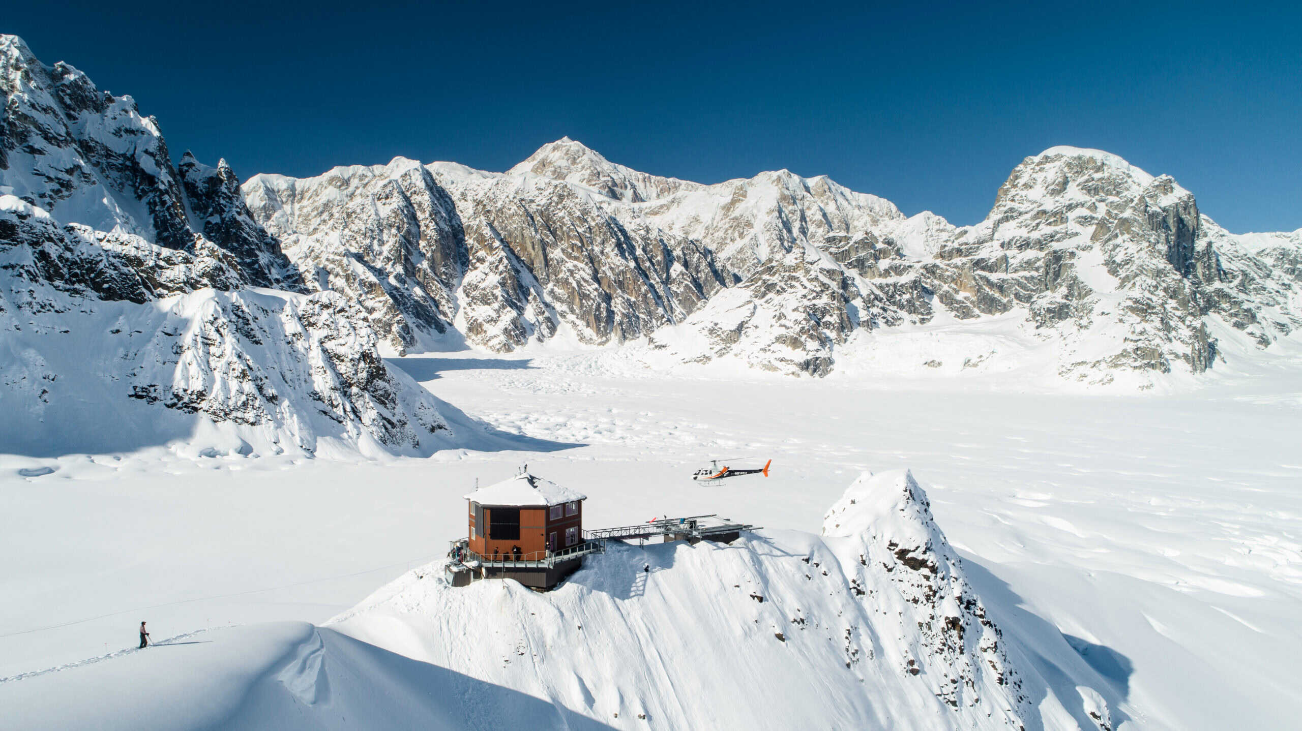 Helicopter visiting hotel property in an arctic setting