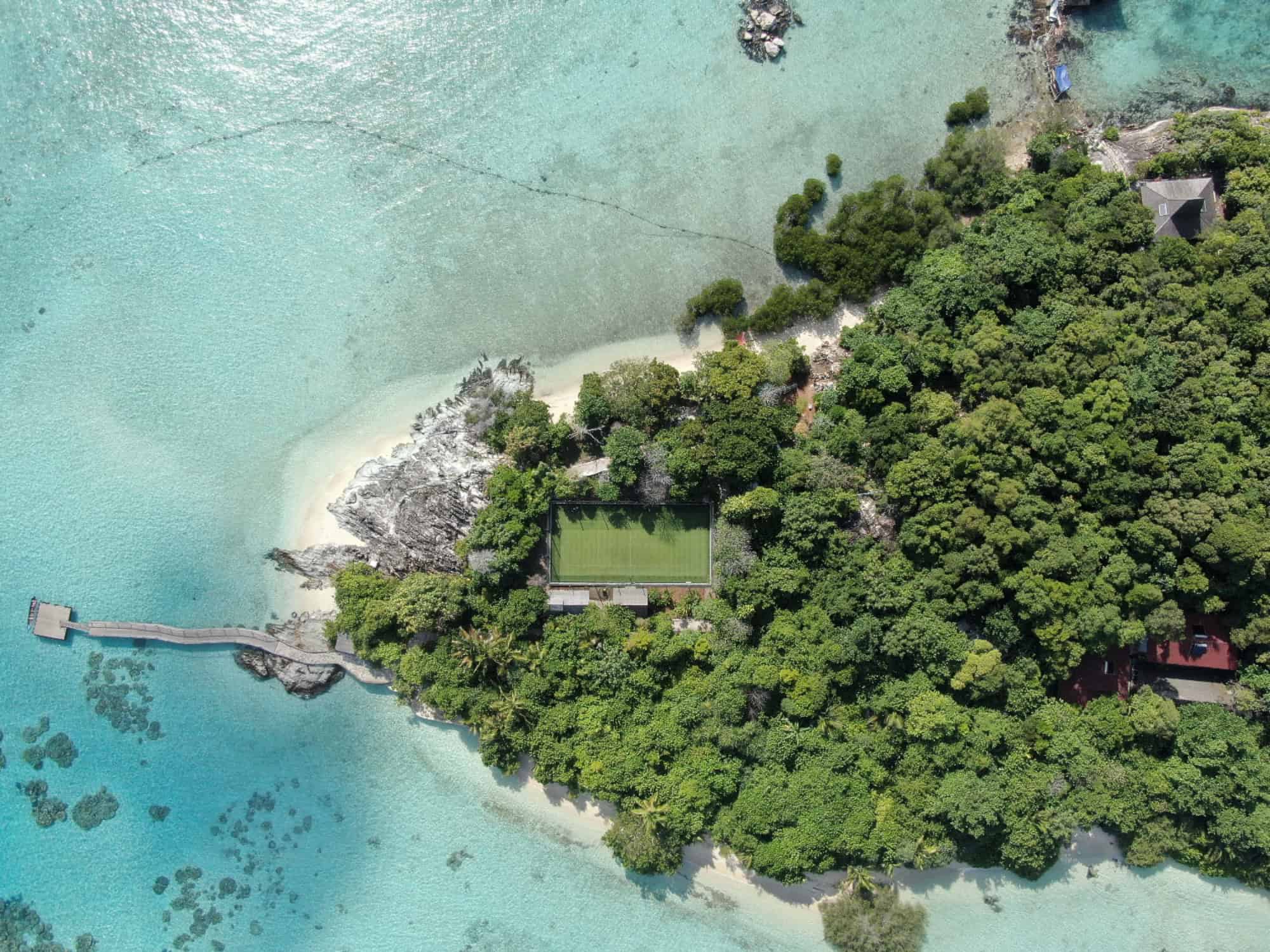 Aerial shot of a tennis court on a beach.