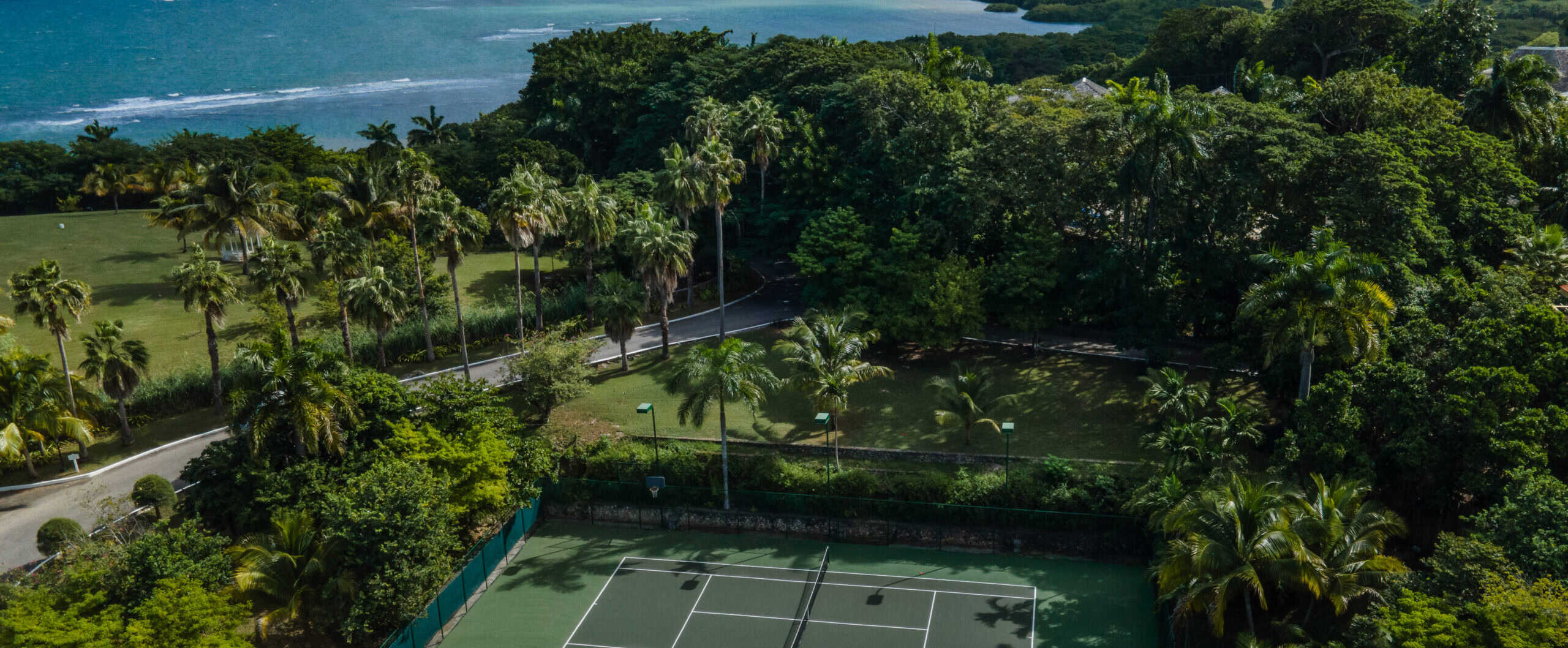 Tennis court by the ocean in a tropical setting