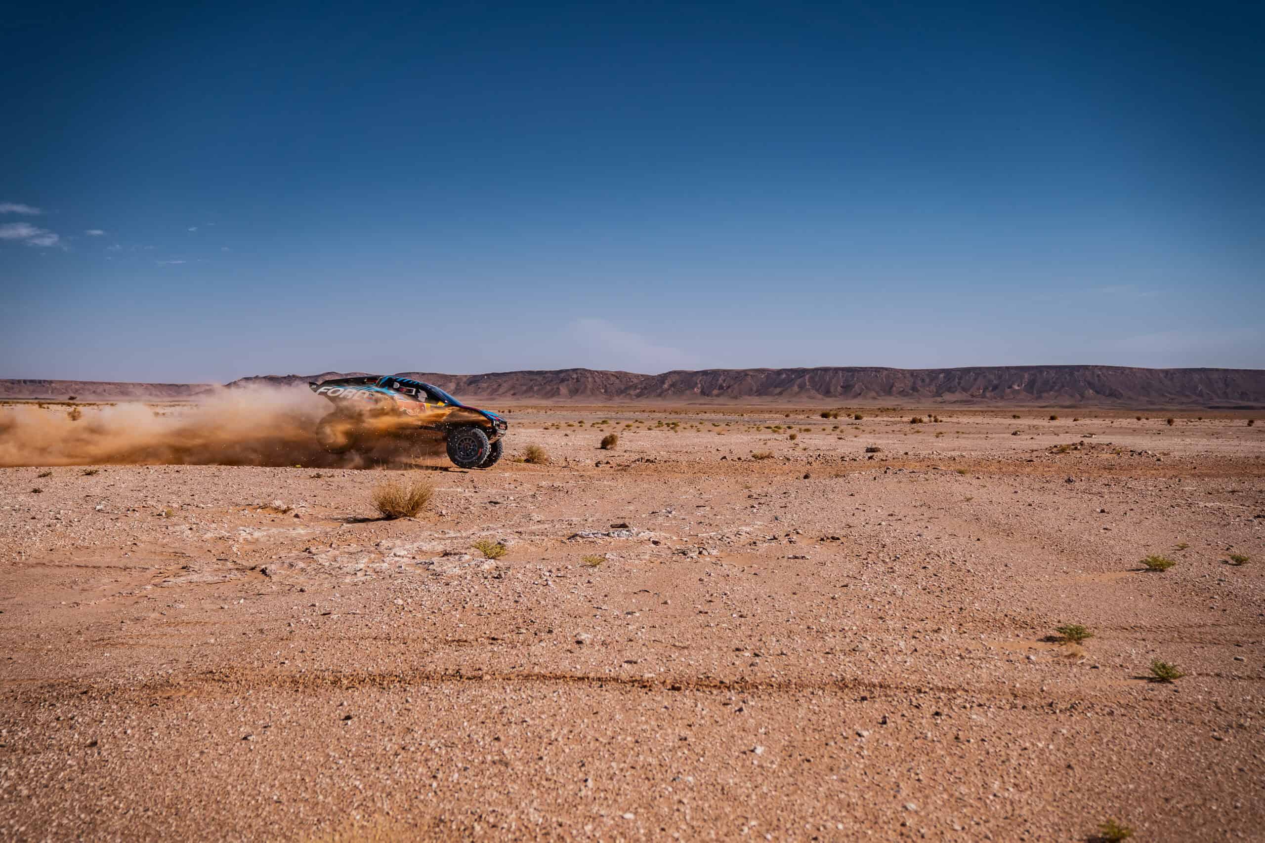 Car speeding through sand