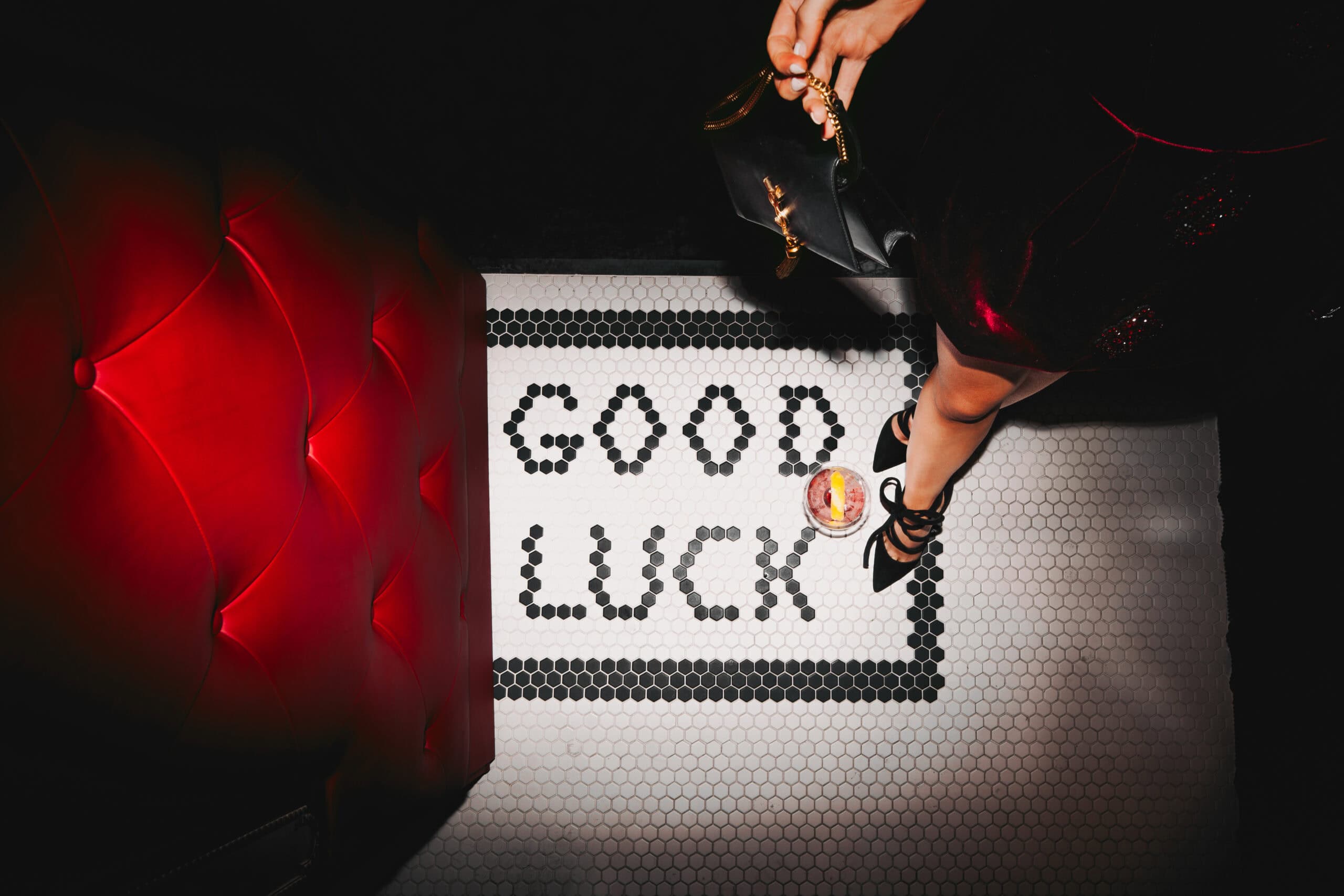 Downward view of a drink and a woman's leg