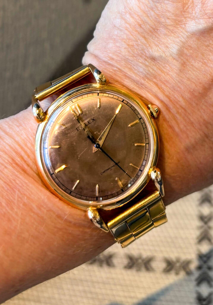 Luxury gold wristwatch with minimalist design and sleek gold bracelet.