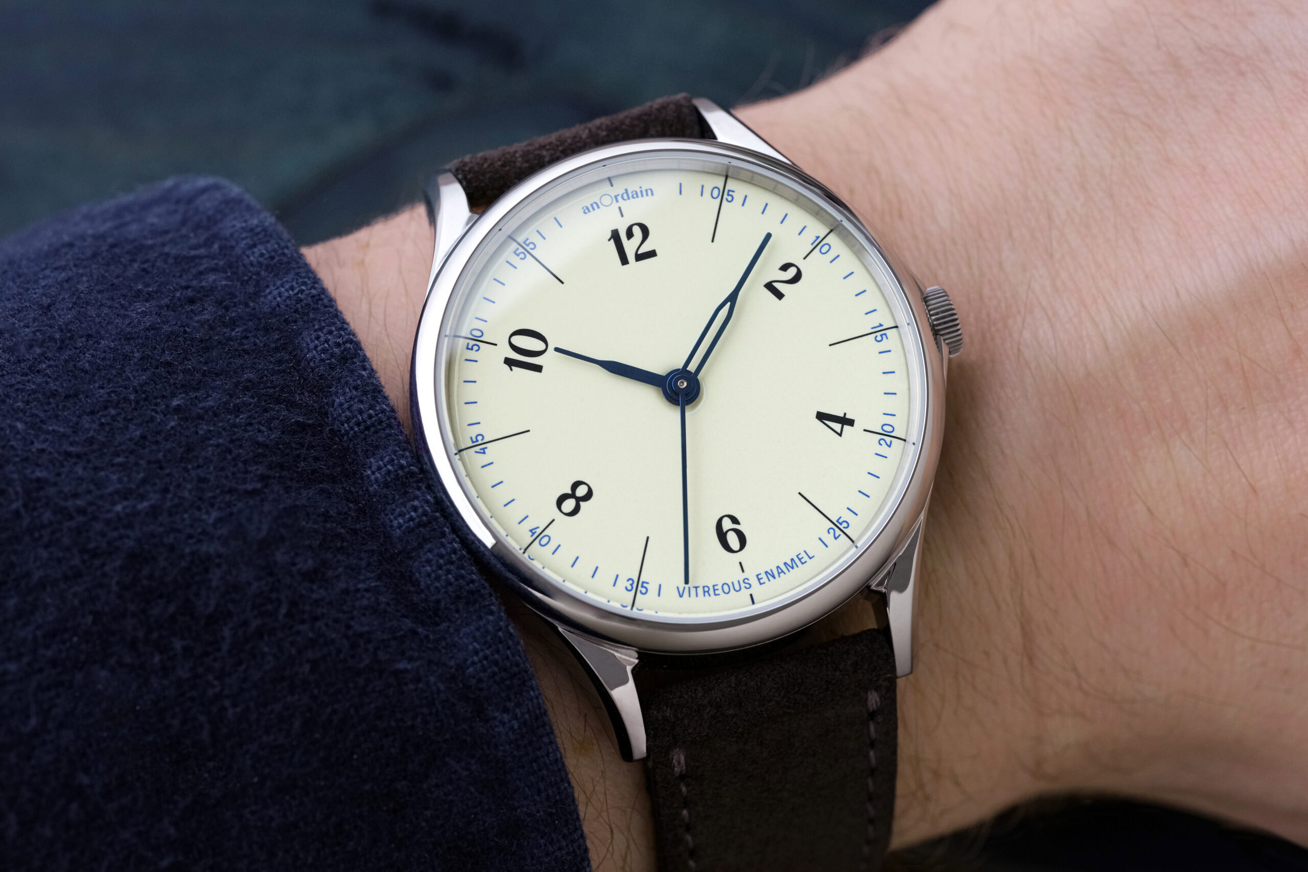 Elegant wristwatch with cream dial and black leather strap.